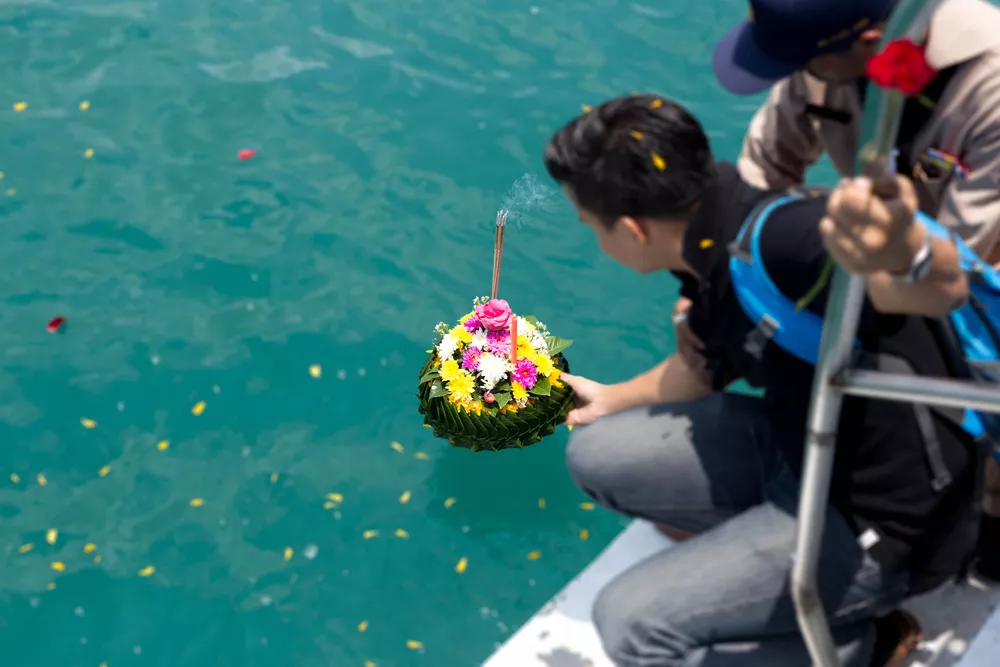 Une personne disperse des cendres en mer